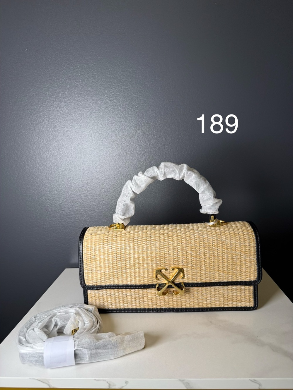 Off-White Woven Straw Shoulder Bag with Black Trim and Gold Hardware